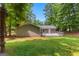 Back of house featuring a large deck and beautiful landscaping in backyard at 810 Bedford Park, Peachtree City, GA 30269