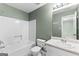 Bright bathroom featuring a shower-tub combo, toilet, and vanity with ample counter space at 810 Bedford Park, Peachtree City, GA 30269