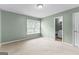 Bedroom with neutral carpet, window, and en-suite bathroom access at 810 Bedford Park, Peachtree City, GA 30269