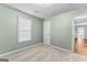 Inviting bedroom featuring soft carpeting, natural light, and a spacious closet at 810 Bedford Park, Peachtree City, GA 30269