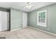 Cozy bedroom featuring carpet, a ceiling fan, closet, and natural light at 810 Bedford Park, Peachtree City, GA 30269