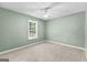 Neutral-toned bedroom featuring carpet, ceiling fan, and window with blinds at 810 Bedford Park, Peachtree City, GA 30269