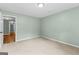 Empty bedroom with plush carpeting, neutral walls, and a trimmed doorway at 810 Bedford Park, Peachtree City, GA 30269