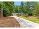 Cozy single-story house with landscaped front yard and driveway, surrounded by mature trees at 810 Bedford Park, Peachtree City, GA 30269