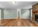 Open-concept living room with hardwood flooring, natural light, and a stone fireplace at 810 Bedford Park, Peachtree City, GA 30269