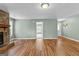Bright living room featuring wood floors, and stone fireplace at 810 Bedford Park, Peachtree City, GA 30269