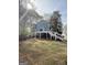 Spacious backyard featuring a deck, patio area, and beautiful landscaping with mature trees and water views at 107 Terrane Rdg, Peachtree City, GA 30269