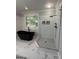 Luxurious bathroom featuring a modern bathtub, glass-enclosed shower, and stylish fixtures for relaxation at 107 Terrane Rdg, Peachtree City, GA 30269