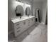 This renovated bathroom features double sinks, black fixtures, and elegant marble flooring at 107 Terrane Rdg, Peachtree City, GA 30269
