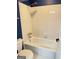 Bathroom with white tiled shower, bathtub combo with chrome showerhead, and blue accent wall at 107 Terrane Rdg, Peachtree City, GA 30269