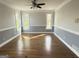 Bright dining room with hardwood floors, neutral decor, and large windows offering natural light at 107 Terrane Rdg, Peachtree City, GA 30269