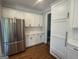 Bright kitchen with stainless steel refrigerator and white cabinets offering ample storage space at 107 Terrane Rdg, Peachtree City, GA 30269