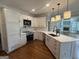 Modern kitchen featuring white cabinetry, marble countertops, and stainless steel appliances at 107 Terrane Rdg, Peachtree City, GA 30269