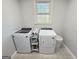 Functional laundry room with modern appliances and patterned tile flooring, combining style with convenience at 107 Terrane Rdg, Peachtree City, GA 30269