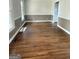 Spacious room featuring hardwood floors and neutral paint with views into the adjacent kitchen at 107 Terrane Rdg, Peachtree City, GA 30269