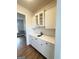 Modern wet bar featuring white cabinets, marble countertop, and stainless steel sink at 107 Terrane Rdg, Peachtree City, GA 30269