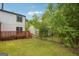 A large backyard with a lattice-patterned back deck provides plenty of space to enjoy the outdoors at 2049 Charter Ln, Lithonia, GA 30058