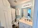 This full bathroom is equipped with shower-tub combo, white vanity, and updated lighting at 2540 Willow Grove Road Nw Rd # 15, Acworth, GA 30101