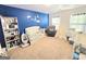 This cozy bedroom features blue walls, a crib, and a comfy chair near sunlit windows at 2540 Willow Grove Road Nw Rd # 15, Acworth, GA 30101