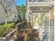 View of the exterior brick and siding of townhome at 2540, featuring a one-car garage and manicured front garden at 2540 Willow Grove Road Nw Rd # 15, Acworth, GA 30101