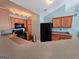 Kitchen featuring wood cabinets, black appliances and breakfast bar at 2540 Willow Grove Road Nw Rd # 15, Acworth, GA 30101