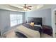 Relax in this bedroom featuring a dark bed set, ceiling fan, and lots of natural light at 2540 Willow Grove Road Nw Rd # 15, Acworth, GA 30101