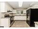 Modern kitchen with white cabinets, granite countertops, and stainless steel appliances at 2624 Windridge Dr, Acworth, GA 30102