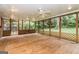 Screened-in sunroom with wooden flooring and lattice trim offers relaxing outdoor views at 2624 Windridge Dr, Acworth, GA 30102