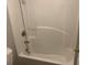 Bathroom shower and tub showcasing a shower head, and a white tiled interior at 165 Lakeside Pt, Covington, GA 30016