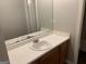 Bathroom vanity featuring a sink and mirror, complemented by vanity lighting at 165 Lakeside Pt, Covington, GA 30016