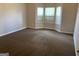 Bedroom with bay window offering plenty of natural light and neutral carpeting at 165 Lakeside Pt, Covington, GA 30016