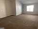 Bedroom featuring neutral carpeting, a ceiling fan, and a window at 165 Lakeside Pt, Covington, GA 30016
