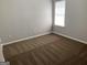 Bedroom with a neutral color scheme, wall-to-wall carpet and a window at 165 Lakeside Pt, Covington, GA 30016