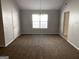 Dining room featuring neutral carpeting and a chandelier at 165 Lakeside Pt, Covington, GA 30016