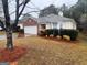 Well-maintained one-story home with brick detail, a two-car garage, and colorful landscaping at 165 Lakeside Pt, Covington, GA 30016
