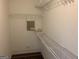 Walk-in closet with ample shelving and carpeting at 165 Lakeside Pt, Covington, GA 30016