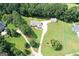 Aerial view of home with sprawling green lawn, long driveway, and mature trees at 2204 Happy Hollow Se Ct, Conyers, GA 30094