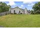 Back view of house, including the expansive backyard, patio furniture and lawn at 301 Bradford Ct, Auburn, GA 30011