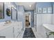 Elegant bathroom featuring dual vanity, stylish mirrors, and a clawfoot tub at 301 Bradford Ct, Auburn, GA 30011