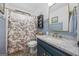 Charming bathroom featuring stylish fixtures, blue vanity, and a unique shower curtain at 301 Bradford Ct, Auburn, GA 30011