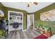 Bedroom offers a built-in desk and shelving, painted green walls, and modern flooring at 301 Bradford Ct, Auburn, GA 30011