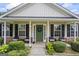 Charming covered front porch with seating, green door, and stylish accents, offering a welcoming entrance at 301 Bradford Ct, Auburn, GA 30011