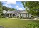 Charming single story home with manicured lawn, mature trees, and colorful flowerbeds adding curb appeal at 301 Bradford Ct, Auburn, GA 30011