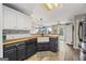 Kitchen island features a farmhouse sink, wooden countertops, and an open view of the living area at 301 Bradford Ct, Auburn, GA 30011
