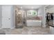 Bright bathroom featuring a soaking tub, glass enclosed shower, and stone tiling at 8 Saint Charles Ave, Sharpsburg, GA 30277