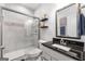 Well-lit bathroom features a glass-enclosed shower and a sleek vanity for a modern and functional space at 8 Saint Charles Ave, Sharpsburg, GA 30277