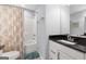 Well-lit bathroom with granite vanity, shower/tub combo and modern fixtures at 8 Saint Charles Ave, Sharpsburg, GA 30277