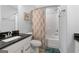 Well-lit bathroom with granite vanity, shower/tub combo and modern fixtures at 8 Saint Charles Ave, Sharpsburg, GA 30277