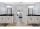 Open view of a bathroom with dual vanities and a bedroom in the background, offering a glimpse of the home's layout at 8 Saint Charles Ave, Sharpsburg, GA 30277