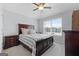 Bedroom with a ceiling fan, double windows, and a dark wood bed at 8 Saint Charles Ave, Sharpsburg, GA 30277